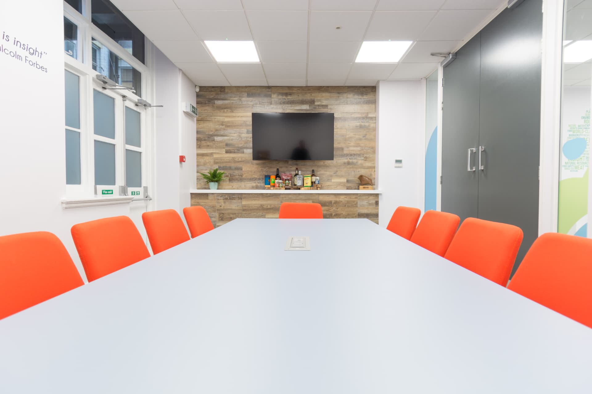 Boardroom-style meeting room with reclaimed timber feature wall